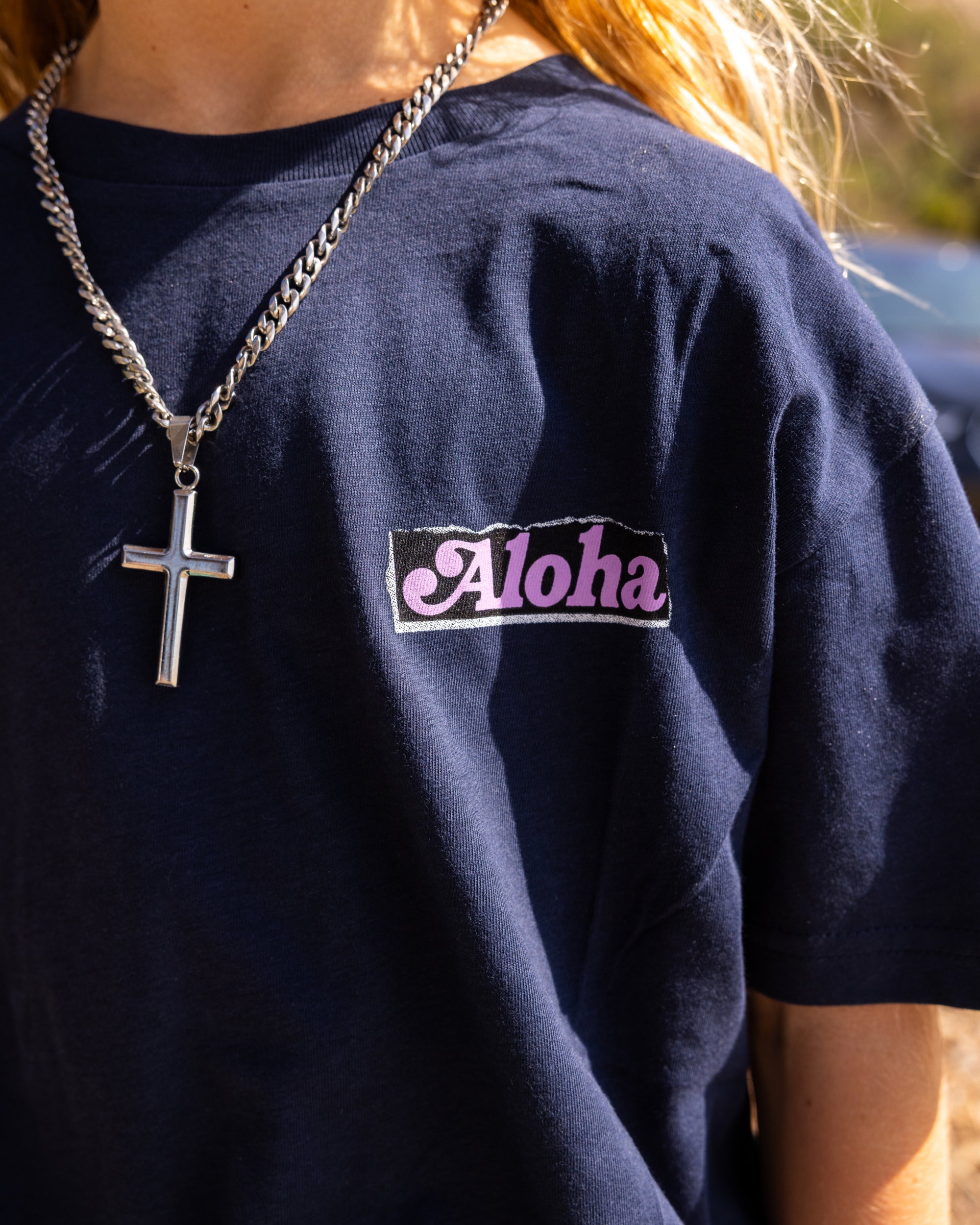 Fun Day Surf Aloha Youth Tee in Navy chest print close-up, lifestyle view