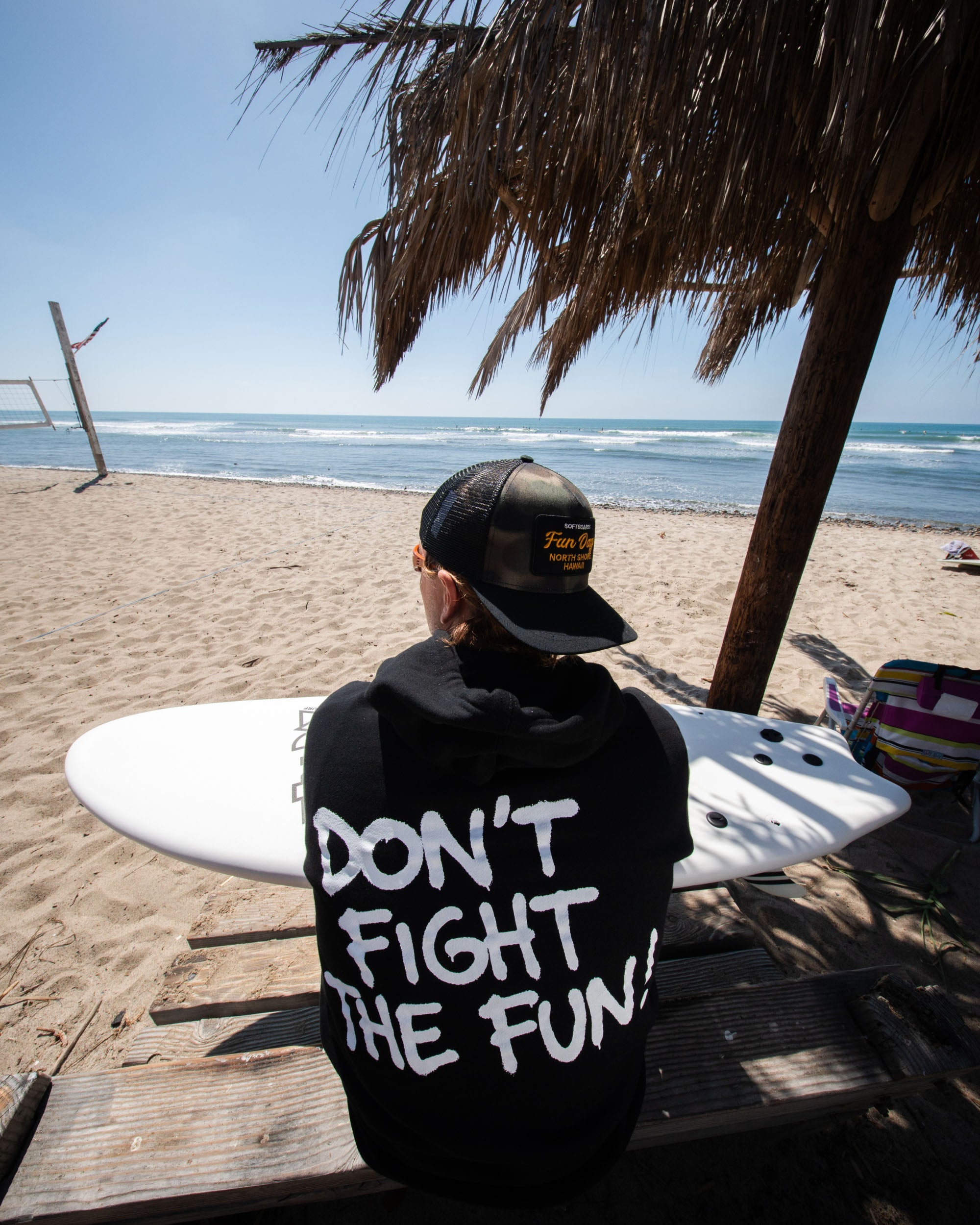 Fun Day Surf DFTF Hoodie in Black back graphic worn at the beach, lifestyle view