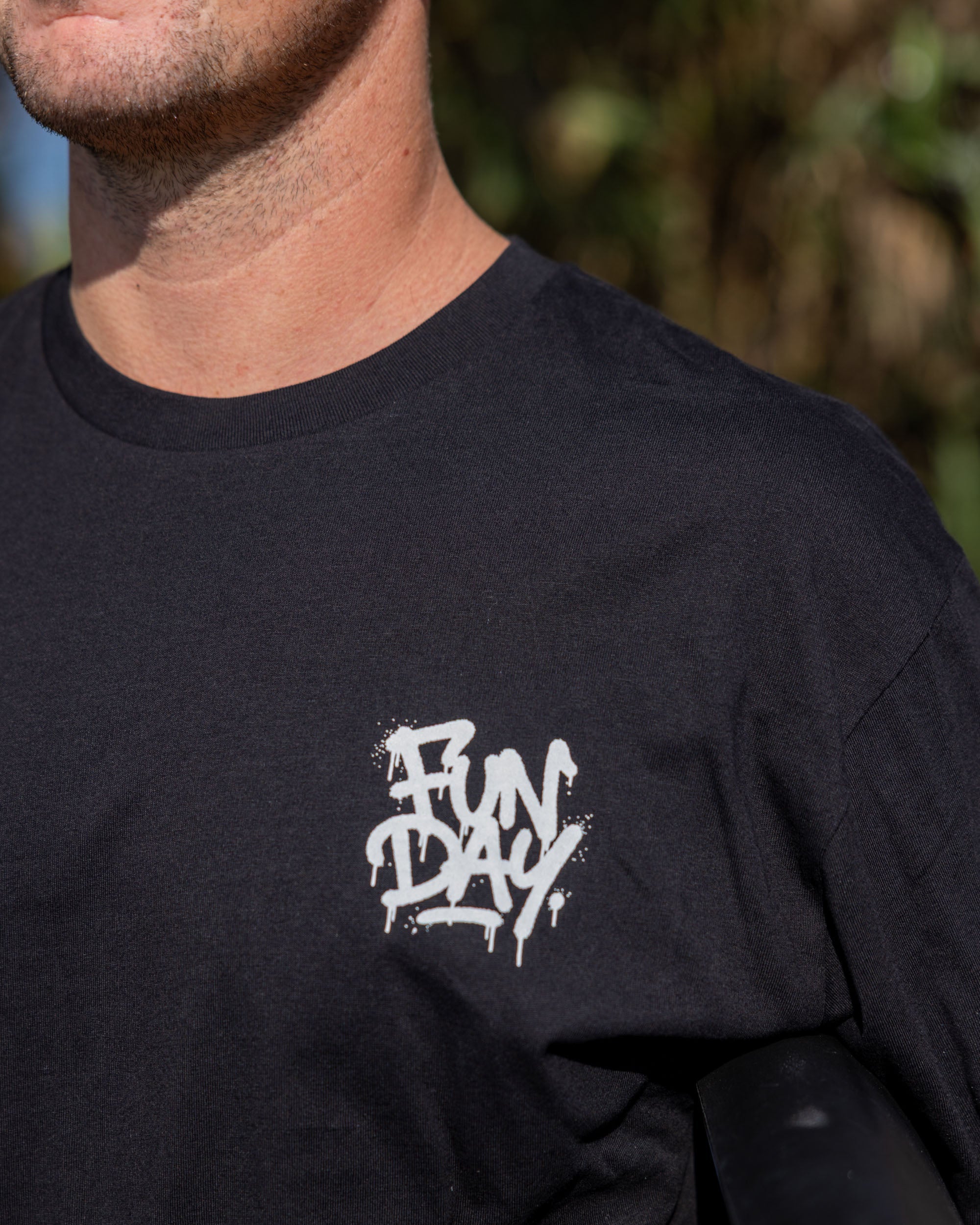 Fun Day Surf DFTF Tee in Black chest print close-up, lifestyle view