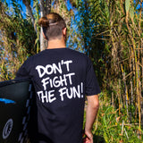 Fun Day Surf DFTF Tee in Black back graphic worn with a surfboard, lifestyle view