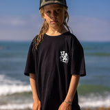 Fun Day Surf DFTF Youth Tee in Black worn at the beach, lifestyle view
