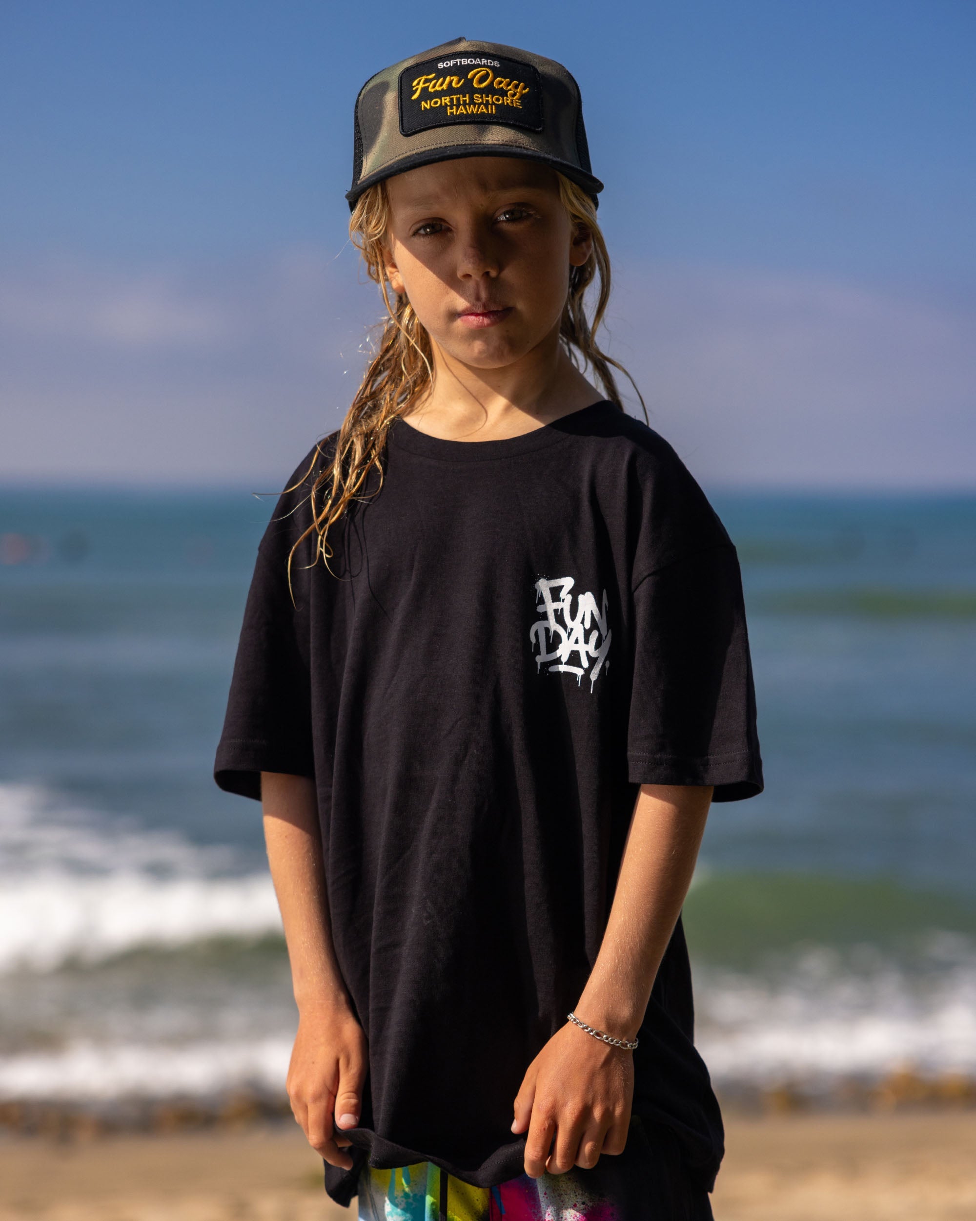 Fun Day Surf DFTF Youth Tee in Black worn at the beach, lifestyle view