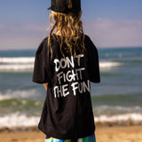 Fun Day Surf DFTF Youth Tee in Black back graphic worn at the beach, lifestyle view