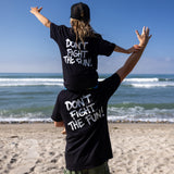 Fun Day Surf DFTF Youth Tee in Black back graphic worn at the beach, lifestyle view
