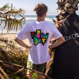 Fun Day Surf Framework Fill Tee in White back graphic worn with a surfboard, lifestyle view