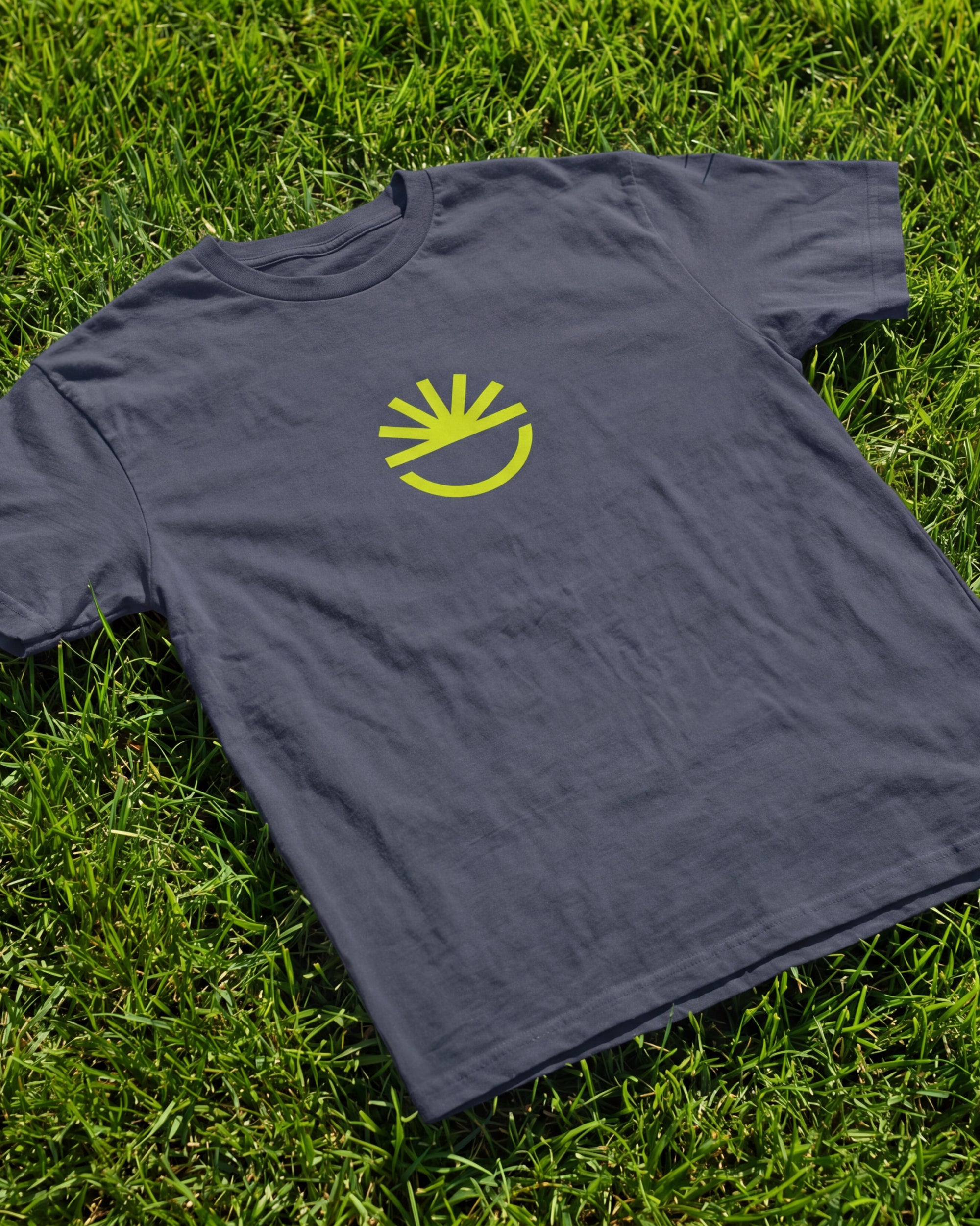 Fun Day Surf Fun Sun Tee in Harbor Blue laid flat on grass, lifestyle view