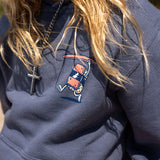 Fun Day Surf Musubi Youth Hoodie in Steel Blue chest print close-up, lifestyle view