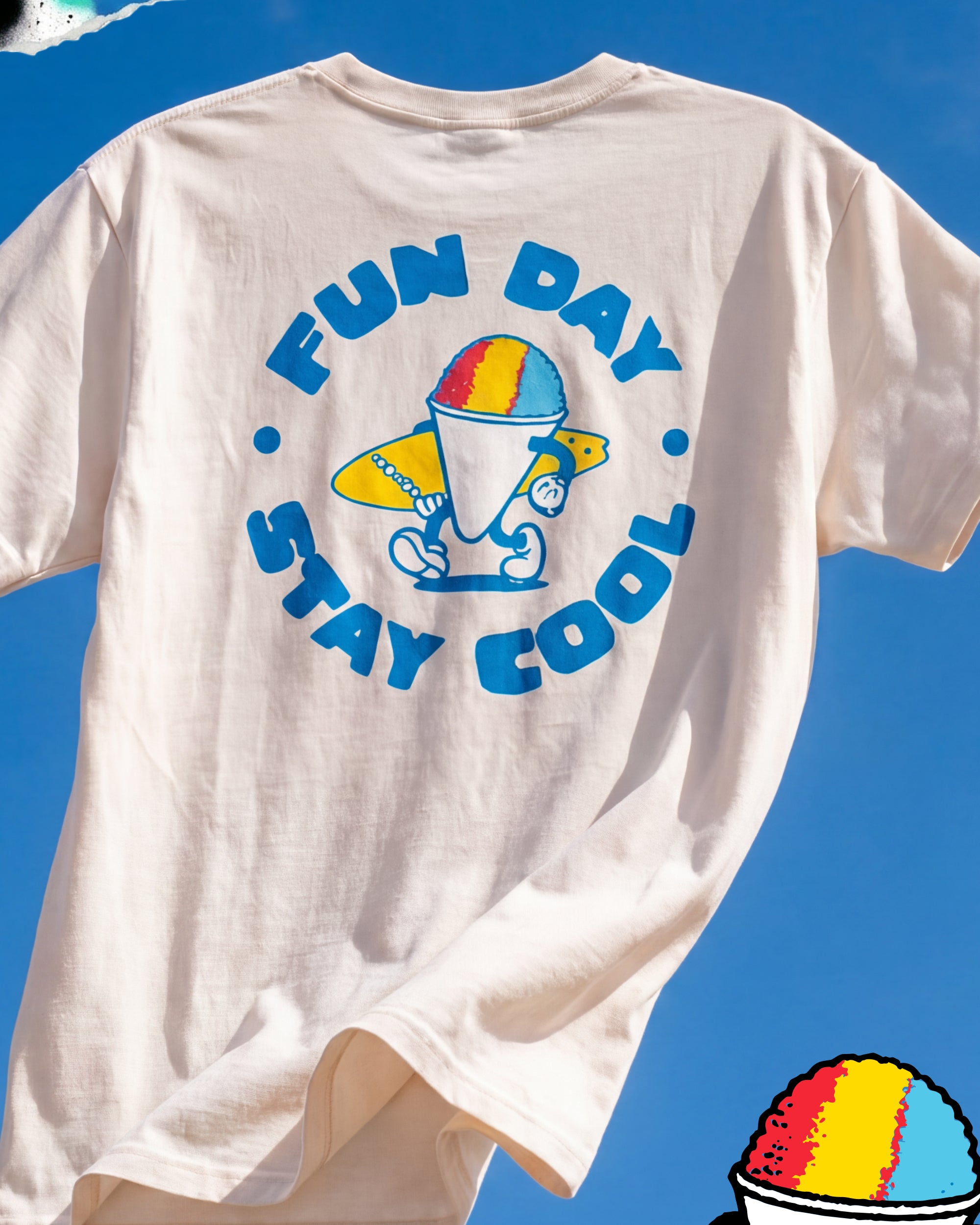 Fun Day Surf Stay Cool Tee in Vintage White back graphic against a blue sky, lifestyle view