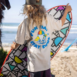 Fun Day Surf Stay Cool Youth Tee in Bone back graphic worn with a surfboard, lifestyle view
